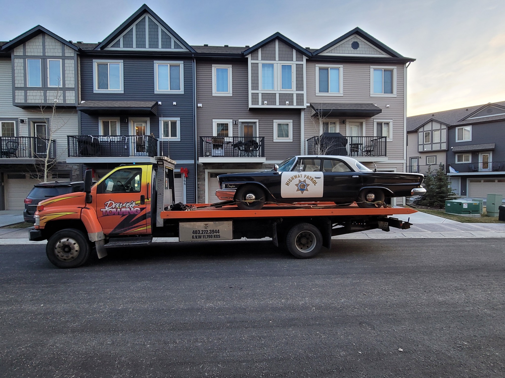 Classic highway patrol car transported on flatbed